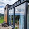 Tiny House  mit Empore – Panorama-Fensterfront über volle Höhe – Zeitgenössischer Chalet-Stil
